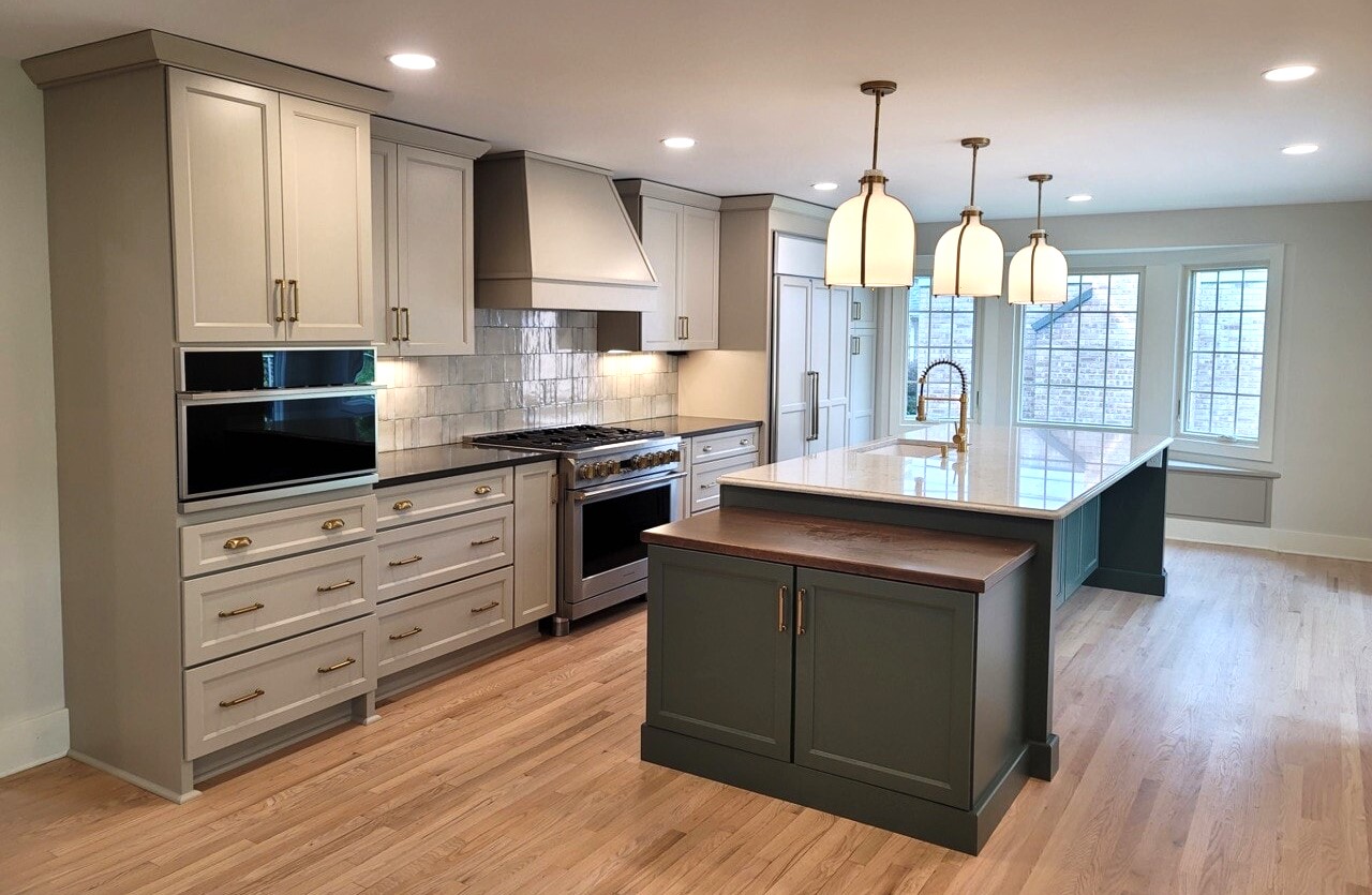 An open kitchen built and designed by Reliable Building Services, Inc. with marble accents and a marble countertop